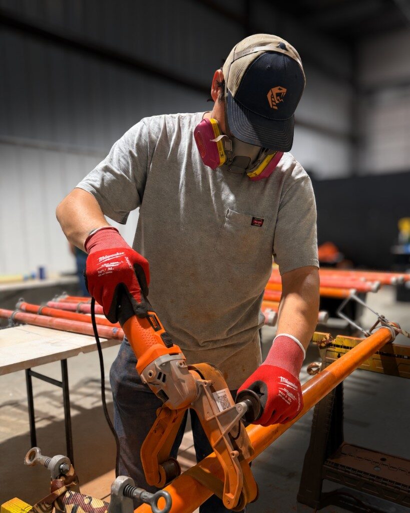 Technician refinishing electrical safety equipment